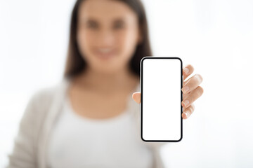Modern smartphone with white blank screen in female hand