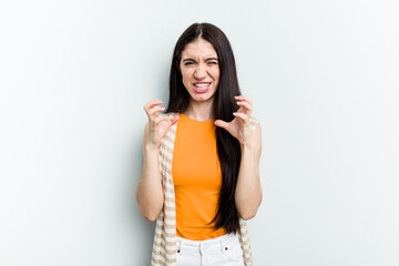 Young caucasian woman isolated on white background upset screaming with tense hands.