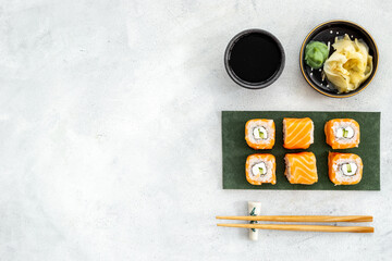 Sushi rolls set with salmon on green papper plate
