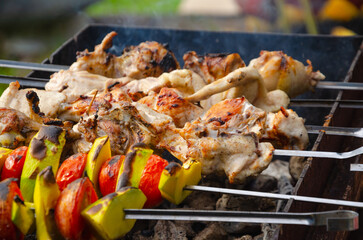 barbecue of vegetables , zucchini and tomatoes on the fire