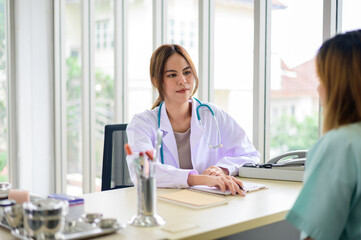 Doctor questioning patient in office and writing answers in clipboard