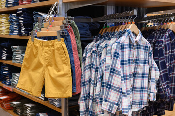 New arrival shirt and trousers hanging in clothes shop