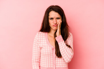 Young caucasian woman isolated on pink background having a strong teeth pain, molar ache.