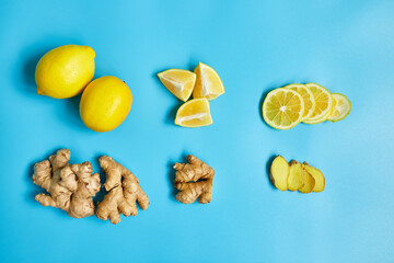 Flat lay of Immune boosting remedy, immunity boosting foods ginger and  lemon on blue background Top view, copy space