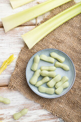 Jelly celery candies on white wooden background. close up, top view.