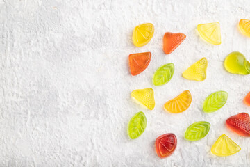 Various fruit jelly candies on gray concrete background. copy space, top view.