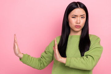 Photo of sad young lady show stop wear green sweater isolated on pink color background