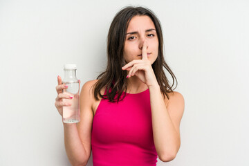 Young caucasian woman holding a bottle of water isolated on white background keeping a secret or asking for silence.