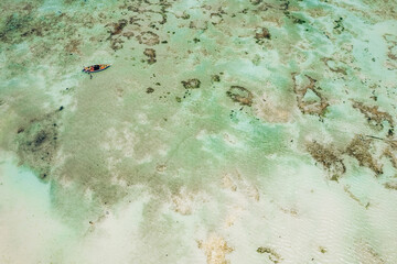 Top view or aerial view of Beautiful crystal clear water and fishing boat in summer of Zanzibar island