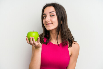Young caucasian woman holding an apple isolated on white background