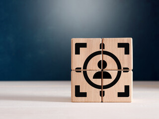 The wooden cubes with focused on target customer symbol.