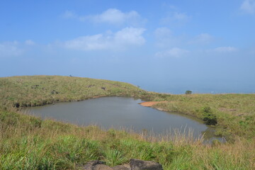 landscape with heart shaped pond and blue sky