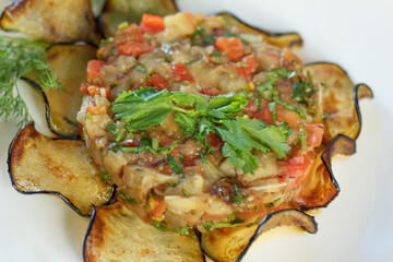 Grilled eggplant salad on a white plate