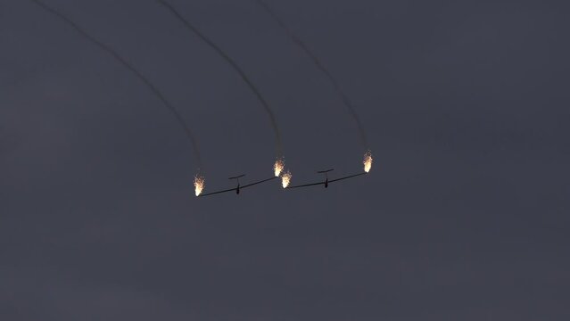 4K video with two gliders in flight with fireworks at the end of them during the International Air Show from Bucharest, Romania.