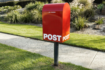 A red australia post letter box stripped of all branding and logos.