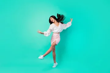 Fotobehang Full body photo of pretty positive malaysian person have fun dancing clubbing isolated on shine emerald color background © deagreez