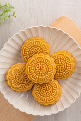 Delicious Cantonese moon cake for Mid-Autumn Festival food mooncake on wooden table background.