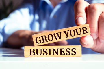 Wooden blocks with words 'GROW YOUR BUSINESS'.