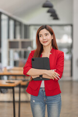 Business Asian Female holding tablet laptop and steanding in the workplace, concept of business accounting documents planning finance analysis and report,
