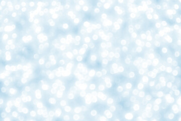 Abstract bokeh light snowfall background.  Soft blue and white bokeh background.  New Year, Christmas, Winter and all celebration background concept. 