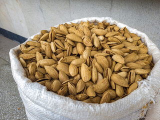Oriental Bazaar. Almond peeled and unpeeled, nuts sales in market. Dry food, variety almonds in store. Concept of healthy eating, raw product, bazaar, diet, almond theme