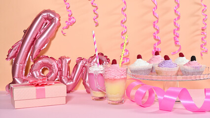 Birthday party table with desserts and candies and balloons
