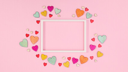Copy space frame with wooden decorative hearts around. Flat lay Valentine's day concept
