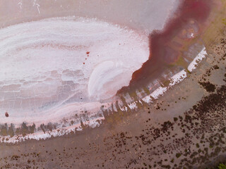Aerial view of colourful patterns and textures in a dry salt lake