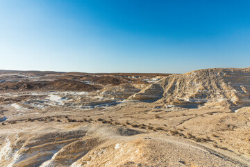 Beautiful lunar landscape. Wight and smooth hills in various shapes in a desert landscape. The whitish, rounded, winding, and smooth chalk rocks. Israel. High quality photo