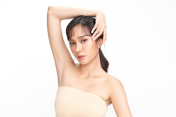 Obraz premium Beautiful Young Asian woman lifting hands up to show off clean and hygienic armpits or underarms on white background, Smooth armpit cleanliness and protection concept