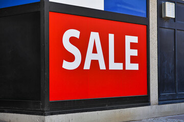 Large red SALE sign in front of shop