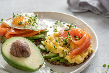 Scrambled eggs with smoked salmon and avocado on toast , Breakfast food
