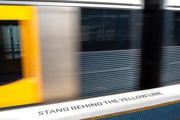 Stand behind the yellow line