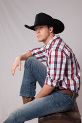 Thoughtful cowboy in plaid shirt and hat