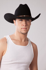 Handsome man in undershirt and western hat