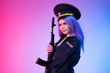 A sexy girl in a military or police uniform poses with a Kalashnikov assault rifle on a neon...