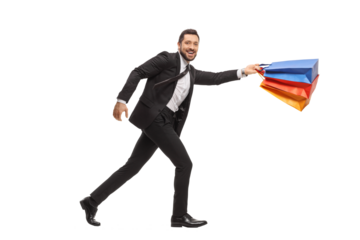 Young businessman running with shopping bags