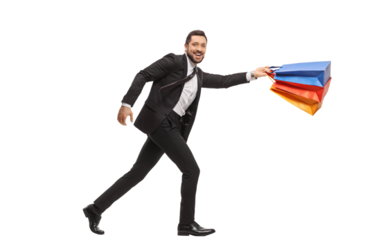 Young businessman running with shopping bags
