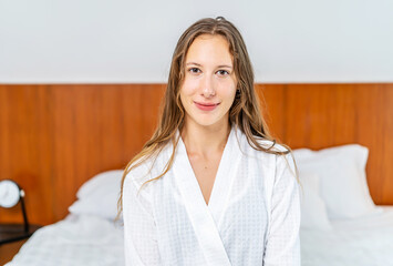 Smiling of cheerful beautiful pretty caucasian woman clean fresh healthy white skin posing in pajamas white clothes.Woman felling relaxing and enjoy time on the bed at home.