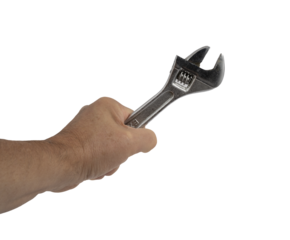 A wrench in the hand of a man on a transparent background