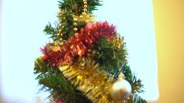 Enlarged image of toys on the Christmas tree. Stylishly decorated Christmas tree. Modern Christmas. New Year.