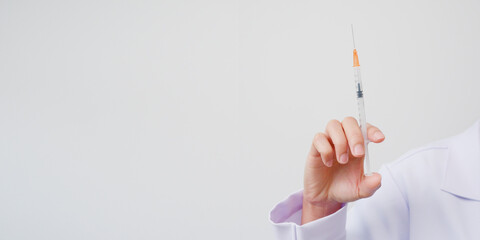 Doctor holding syringe in hospital, health care and medical concept on white background.