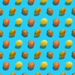 Fresh ripe fruits on color background. Pattern with mango and lemon. A combination of whole fruits on blue background. 
