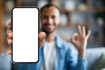 Mobile Offer. Smiling black man demonstrating big smartphone with blank white screen