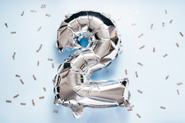 Silber balloon number 2 on light glitter background for your desing