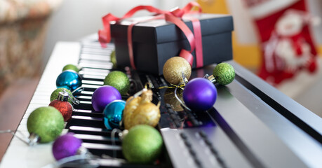 Naklejka na ściany i meble Christmas ball on piano keys. Carol music concept