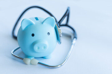 Piggy Bank and Stethoscope Isolated on a White Background.