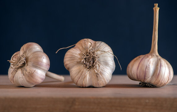 heads of young garlic on a wooden table