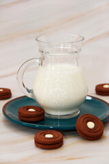 white fermented milk drink ayran in a transparent glass mug and sweet chocolate cookies 