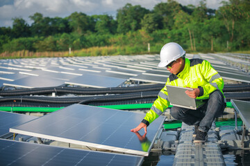 Portrait of professional man engineer working checking the panels at solar energy on buoy floating. Power plant with water, renewable energy source. Eco technology for electric power in industry.